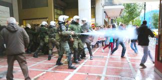 Riot police attack with tear gas spray gun a protesting student outside the central Athens office of the Finance Ministry’s Secretary on Thursday. Photo courtesy left.gr