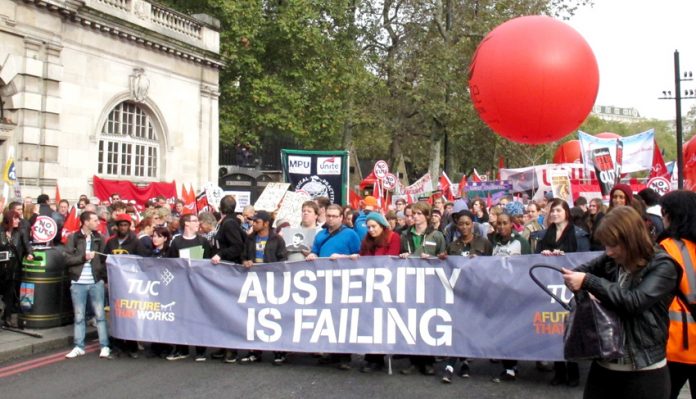 One of the lead banners on the TUC march in London last October 26 – four months later workers are more determined than ever to get rid of the coalition
