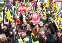 Striking civil servants applauding a call from the Prison Officers Association for a general strike