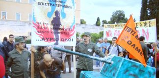 Teachers dressed up as Greek army officers along with the emblem of the military junta of 1967-74 outside the Greek Parliament, after the Greek government’s decision to put teachers under the ‘state emergency civil conscription’ laws’