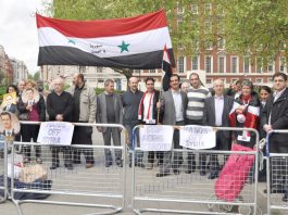 Syrians demonstrate outside the US embassy in London in support of President Assad against the imperialist support for terrorist acts in Syria