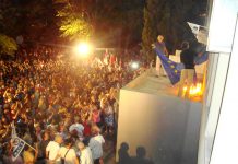 Workers setting a European Union flag on fire at the ERT building in Athens