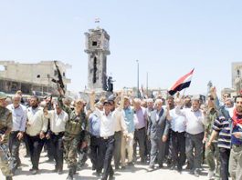 Syrian troops celebrate the liberation of Al-Qusayr near the border with Lebanon