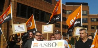 Labour MP TOM WATSON (holding poster on left) joins the GMB demonstration outside McDonald’s headquarters in Finchley yesterday morning