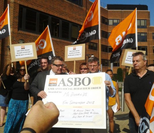 Labour MP TOM WATSON (holding poster on left) joins the GMB demonstration outside McDonald’s headquarters in Finchley yesterday morning