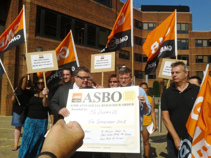 Labour MP TOM WATSON (holding poster on left) joins the GMB demonstration outside McDonald’s headquarters in Finchley yesterday morning