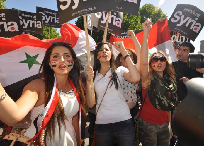 Girls marching in London on August 31, confident of the defeat of imperialist forces in Syria