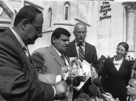 PHIL SHINER of Public Interest Lawyers outside the High Court, standing behind DAOUD MOUSA, seen holding pictures of his son, Baha and his family. Baha was beaten to death by British troops in Basra