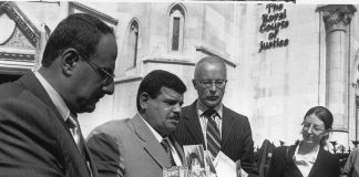 PHIL SHINER of Public Interest Lawyers outside the High Court, standing behind DAOUD MOUSA, seen holding pictures of his son, Baha and his family. Baha was beaten to death by British troops in Basra