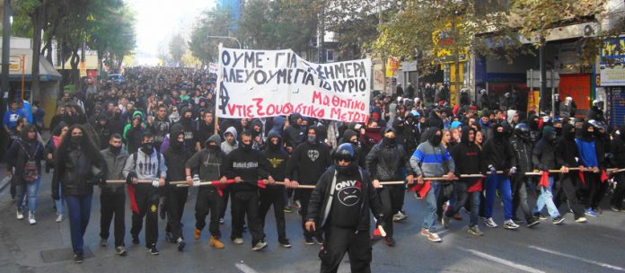 The front of last Friday’s school students’ march in Athens. The banner reads, ‘We live today to fight for tomorrow’ signed by ‘Anti-state power school students’