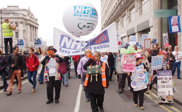 Marchers in London urging: defend the NHS and stop privatisation – the GMB is now fighting an attempt to privatise an elderly people’s service contract in Cambridge which is being presented as a £1bn deal