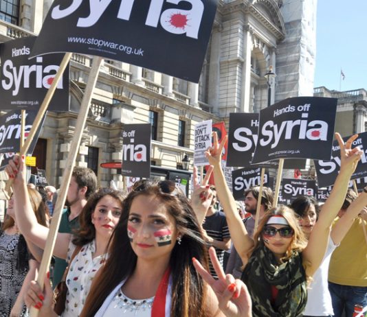 Syrian girls marching in London demanding no foreign intervention against Syria