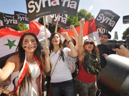 Syrian girls marching in London last August demand no imperialist intervention in Syria