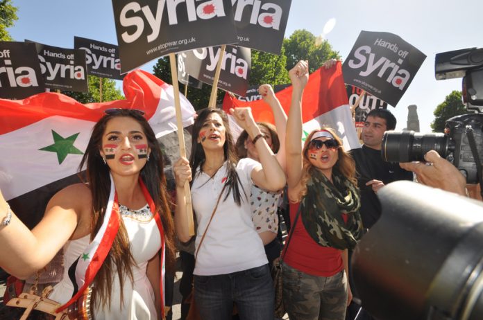 Syrian girls marching in London last August demand no imperialist intervention in Syria