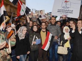 People of Aleppo  marching through the streets of the city on Tuesday to show their support for the Syrian Arab Army