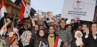 People of Aleppo  marching through the streets of the city on Tuesday to show their support for the Syrian Arab Army