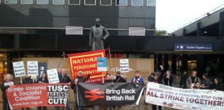 Trade unionists rally outside Euston Station demanding rail re-nationalisation – twenty years after it was privatised in 1993