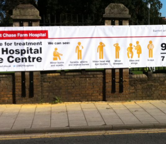 The new 30x6ft banner erected outside Chase Farm Hospital that replaces the 3x3ft sign that was there when a 2-year-old child was taken by his mother to what she thought was the A&E, only to find the door to the Urgent Care Centre was locked. The child di