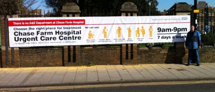 The new 30x6ft banner erected outside Chase Farm Hospital that replaces the 3x3ft sign that was there when a 2-year-old child was taken by his mother to what she thought was the A&E, only to find the door to the Urgent Care Centre was locked. The child di