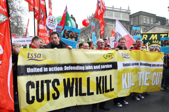 RMT and TSSA members marching against rail cuts that are putting lives at risk