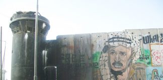 A picture of Yasser Arafat on the Israeli Separation Wall built so that Israel could annex settlements and surround Palestinian areas