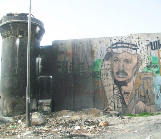 A picture of Yasser Arafat on the Israeli Separation Wall built so that Israel could annex settlements and surround Palestinian areas