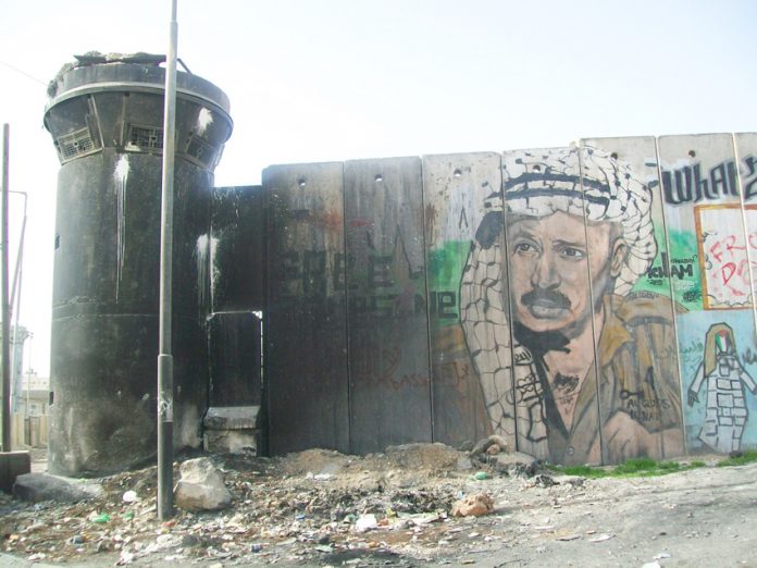 A picture of Yasser Arafat on the Israeli Separation Wall built so that Israel could annex settlements and surround Palestinian areas