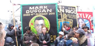Banners of the campaigns of the Mark Duggan and Sean Rigg families on a United Families and Friends demonstration