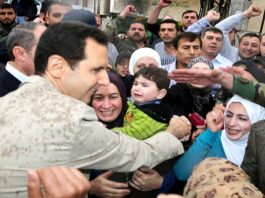 Enthusiastic locals in the village of Ein al-Tineh greet President BASHAR AL-ASSAD