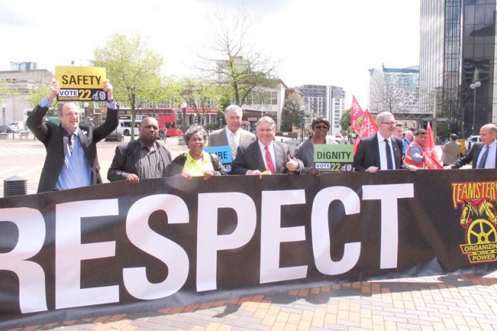 Teamsters leader JAMES HOFFA (centre) standing with Unite leader LEN McCluskEy, emphasised  that US and UK workers are struggling against the same bosses