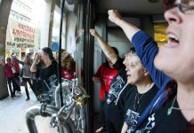 Sacked cleaners occupying the Greek Finance Ministry barricaded themselves in and chained the doors to keep the riot police out. Photo credit: MARIAS LOLOS