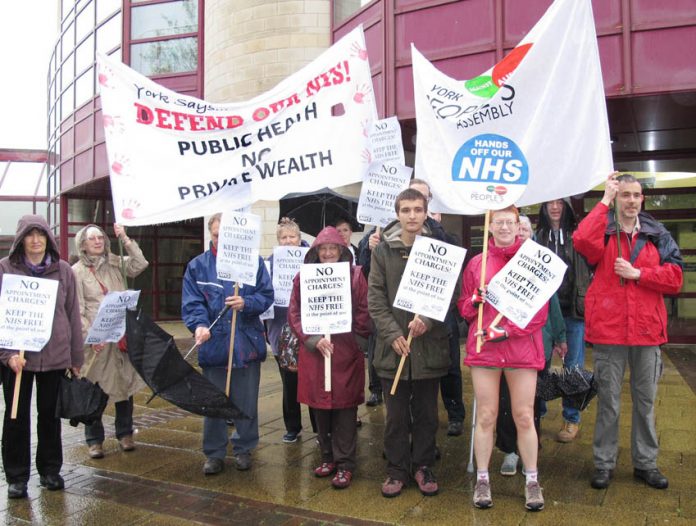 ‘KEEP THE NHS FREE’ demonstrators greet delegates to the GP conference in York – delegates voted for that policy