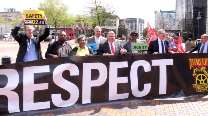 Teamsters union leader James Hoffa (centre) lobbies the National Express shareholders meeting in Birmingham along with Unite leader McCluskey