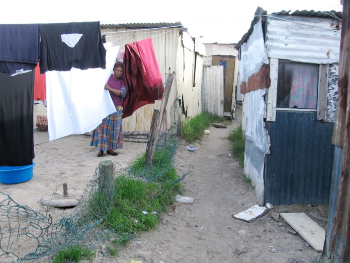 A South African woman living in the Khayelitsha township in Cape Town where there is no running water or electricity