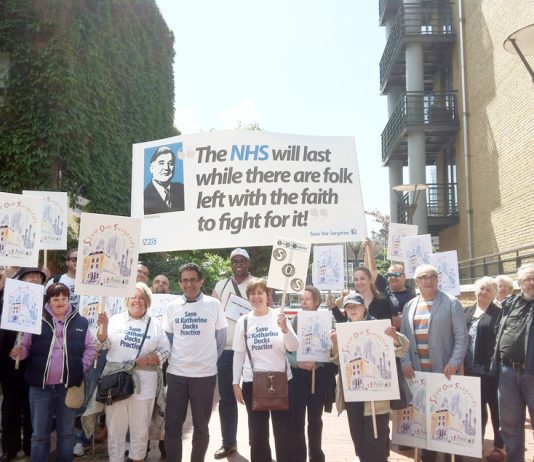 GPs and their supporters with their main banner showing that they are determined to fight to maintain and defend the NHS