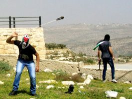 Young Palestinian has only a sling to defend his village from incusions by armed Israeli settlers