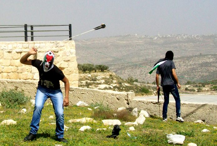 Young Palestinian has only a sling to defend his village from incusions by armed Israeli settlers