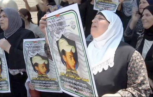 Palestinian women demonstrate against the killing of 15-year-old Muhammad Abu-Khudayr