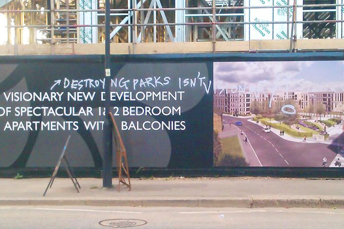 Graffiti on the billboard of the Myatts Field North ‘regeneration’ site. Residents are protesting at their building site conditions