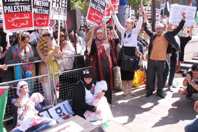 Women at the front of Saturday’s demonstration depicting the Israeli slaughter of Palestinian children in Gaza