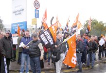 Queen Elizabeth Hospital workers on the picket line yesterday morning, determined to win parity