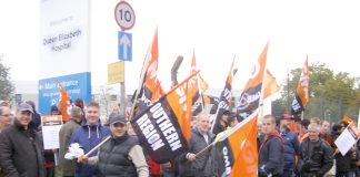 Queen Elizabeth Hospital workers on the picket line yesterday morning, determined to win parity