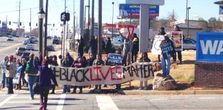 Walmart workers and Ferguson protesters picket a Walmart store in Atlanta