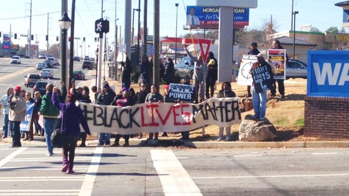 Walmart workers and Ferguson protesters picket a Walmart store in Atlanta
