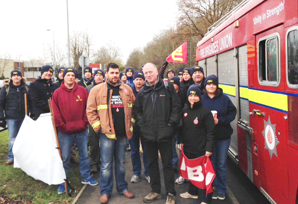 Victimised firefighter RICKY MATTHEWS (left centre) with FBU general secretary MATT WRACK at yesterday’s march in Aylesbury