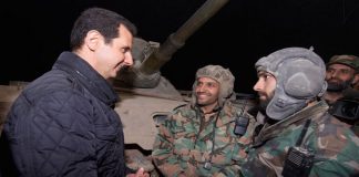 Syrian President BASHAR AL ASSAD greeting soldiers at a military post on the firing line at Jobar in the Damascus coutryside over the New Year