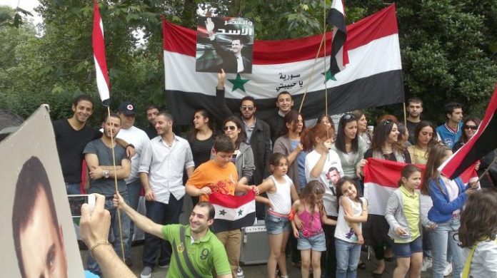 Syrians show their support for President Assad at a demonstration in London