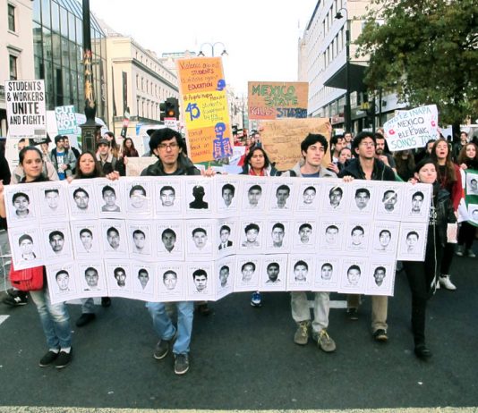 Students on a demonstration against tuition fees in London last November holding pictures of the 43 disappeared Mexican students