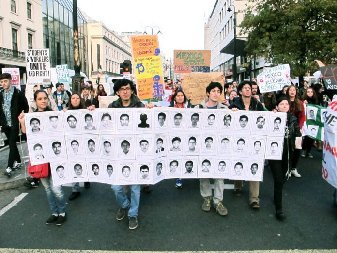 Students on a demonstration against tuition fees in London last November holding pictures of the 43 disappeared Mexican students