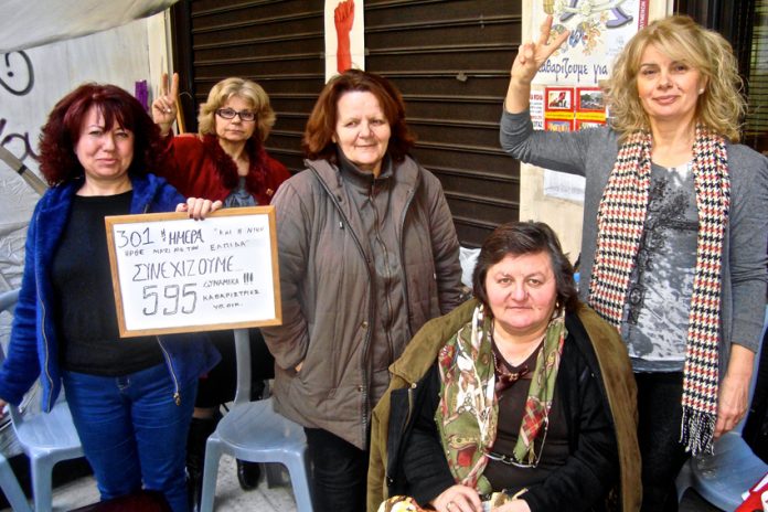 The group of sacked women cleaners at the Camp of Struggle. One of them holds the tablet stating the 301 days of the fight